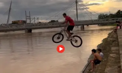 Jovem viraliza ao se jogar de bicicleta no Rio Acre, na capital